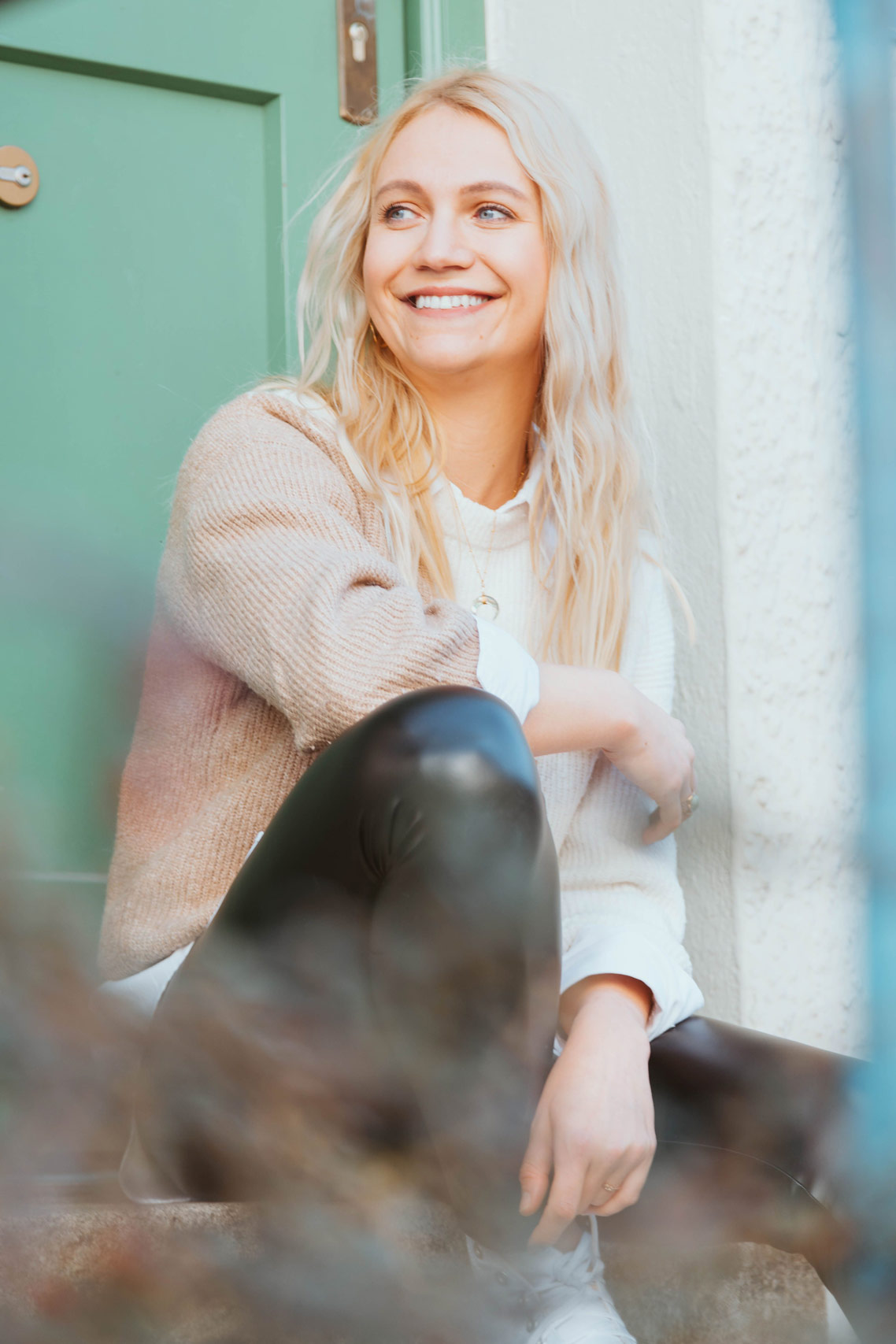 Smiling blonde woman sitting on stairs