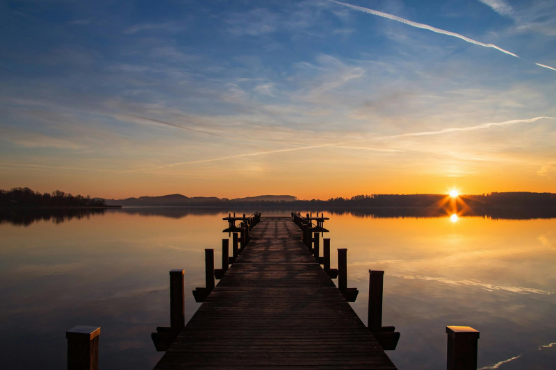 Sunrise at a wooden pier on Lake Wörth in Bavaria