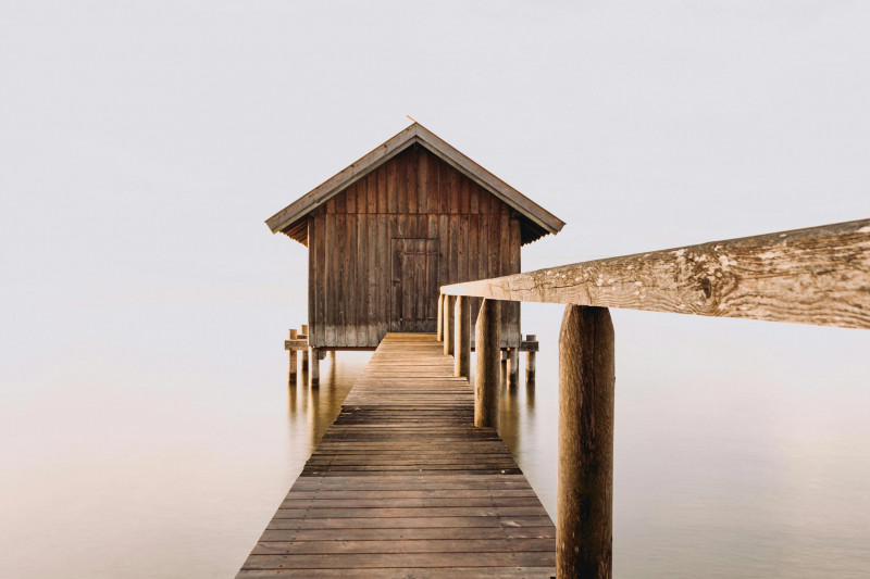 A wooden house at the end of a pier on Lake Ammersee in Bavaria